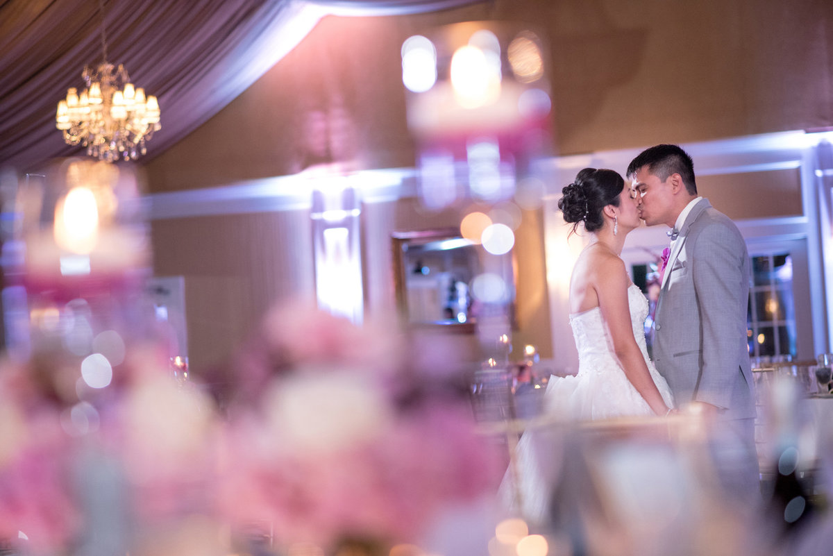 Bride and groom kissing at the ballroom of Bridgeview Yacht Club