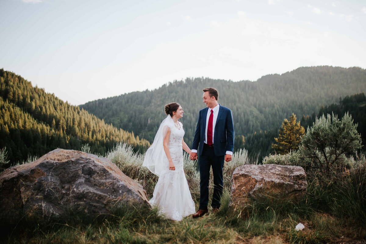 Lake Tahoe wedding photographer captures bride and groom holding hands on top of mountain