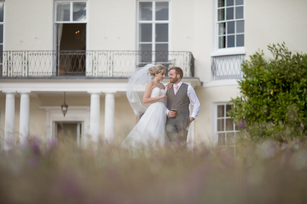 Couple on their wedding day at the front of Rockbeare Manor