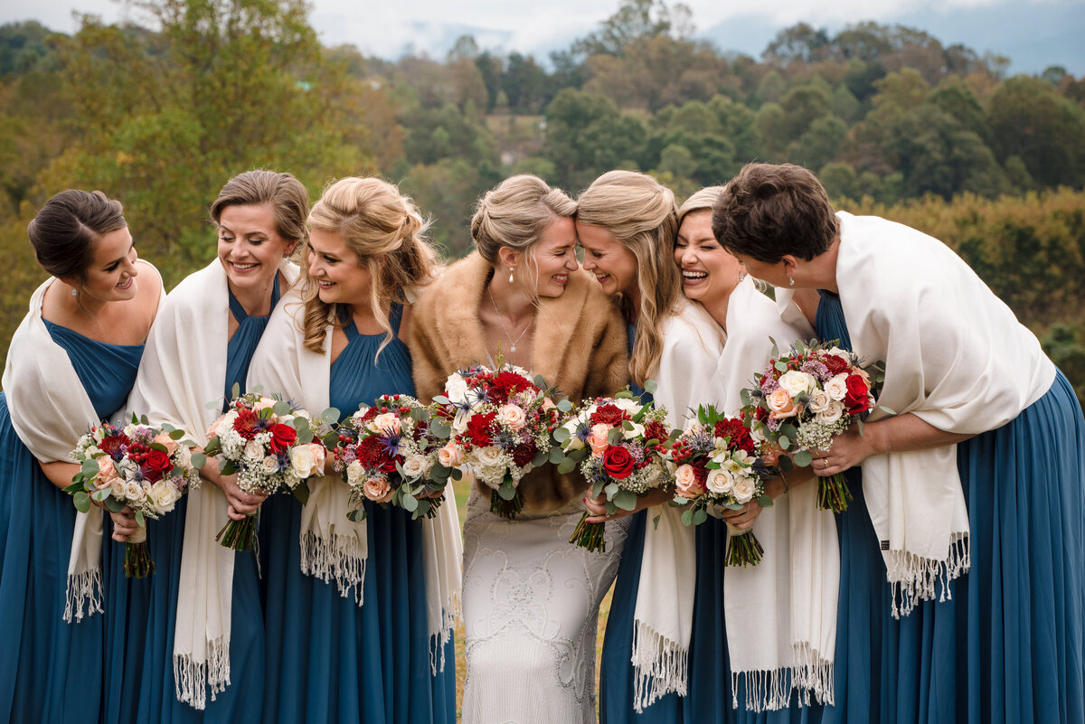 Bride-and-bridesmaid-laughing-as-a-group-outside-in-the-snow-at-The-Pavilion-at-Silver-Fork