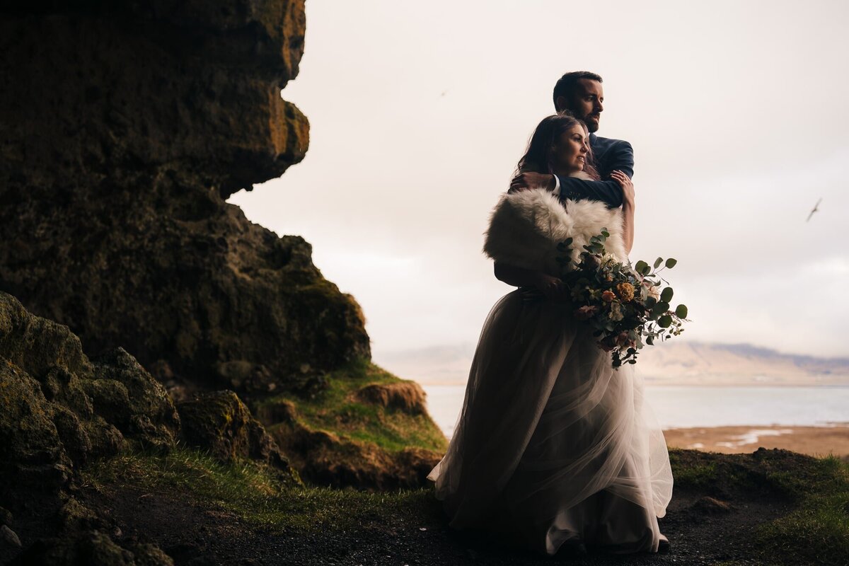 Deep within an Icelandic cave, this couple shares a quiet moment, gazing into the distance, embracing the beauty of their surroundings and the love that brought them there.