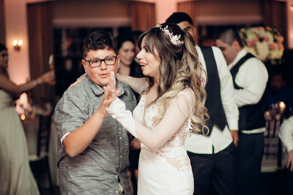 Wedding Photograph Of Man In Gray Polo And Bride Dancing In Side View Los Angeles