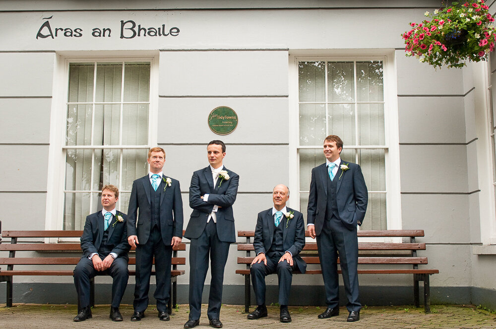 groom and his groomsmen wearing navy suits standing outside the town hall in Killarney