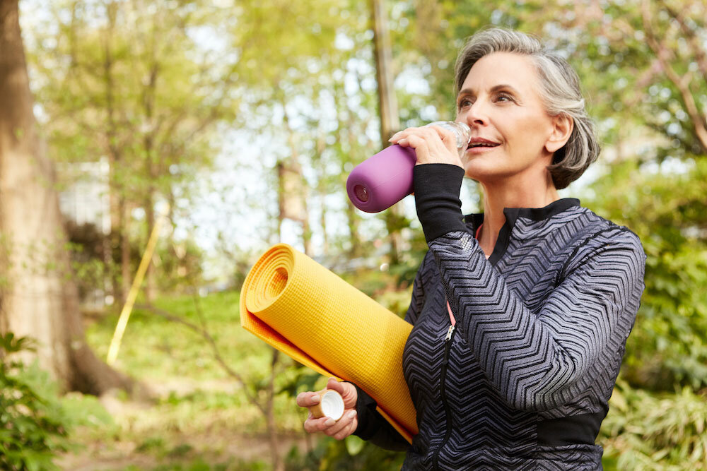 Older healthy athletic woman doing yoga and going for a walk