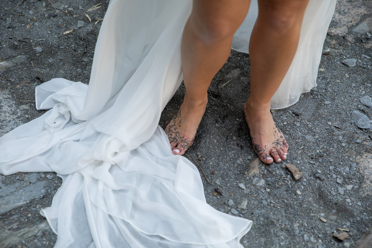 Brides sandy feet at Tunnels Beaches wedding venue in Devon