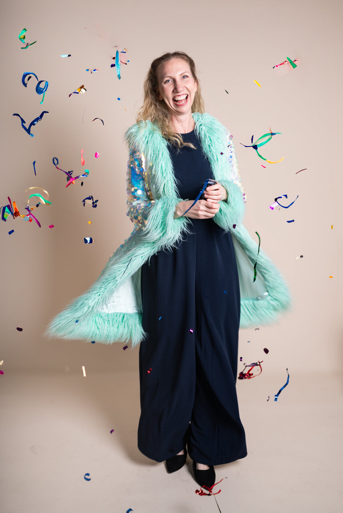 Ingrid-throws-confetti-smiling-during-her-personal-brand-photoshoot-at-a-Baltimore-Studio