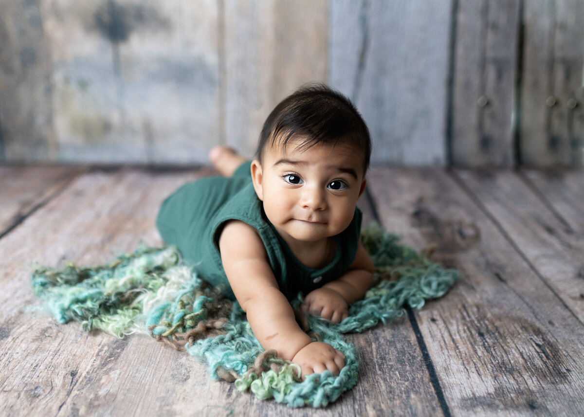 cute baby boy looks at camera for toddler photoshoot in Colorado portrait studio