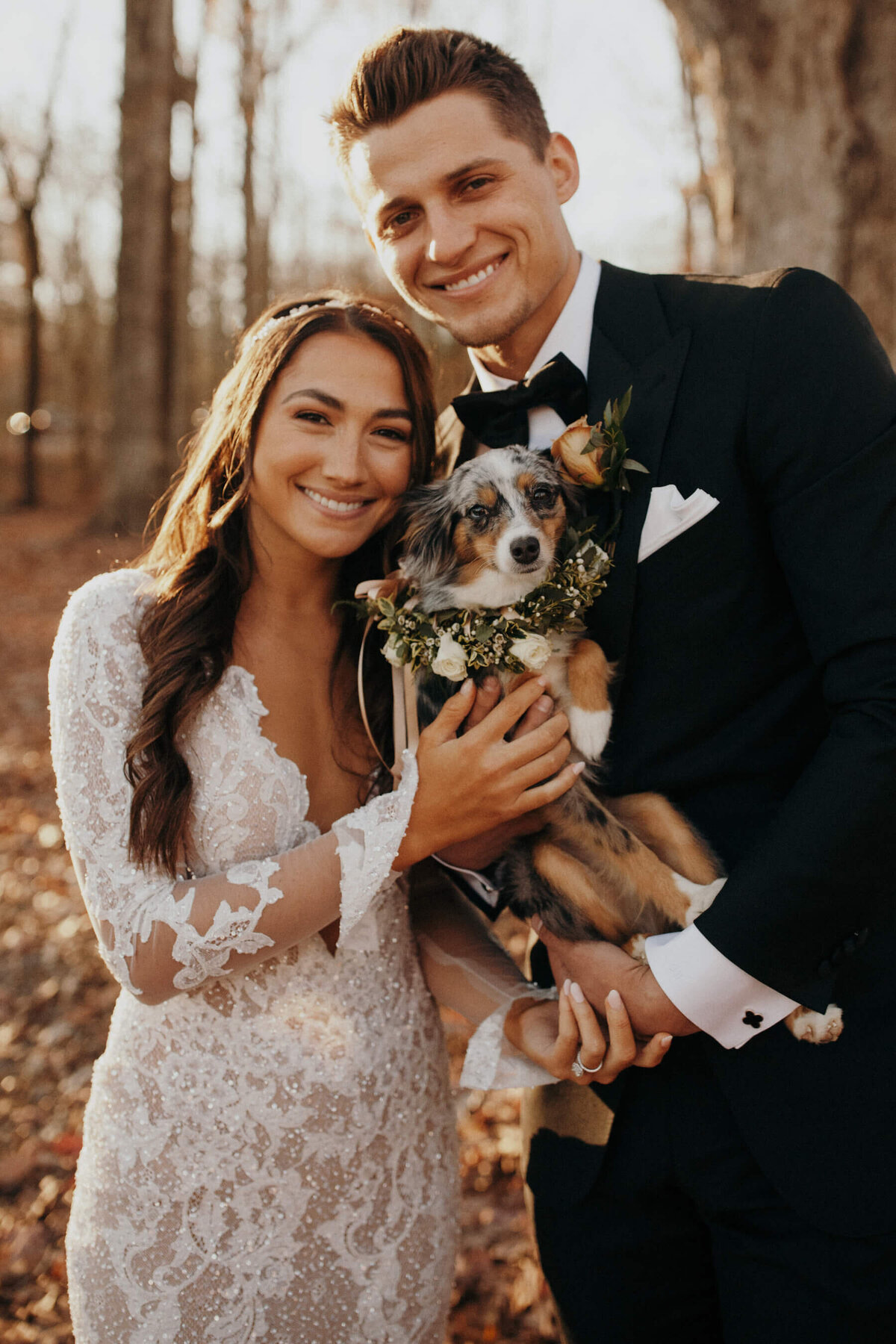 Bride and groom with dog  and flower collar