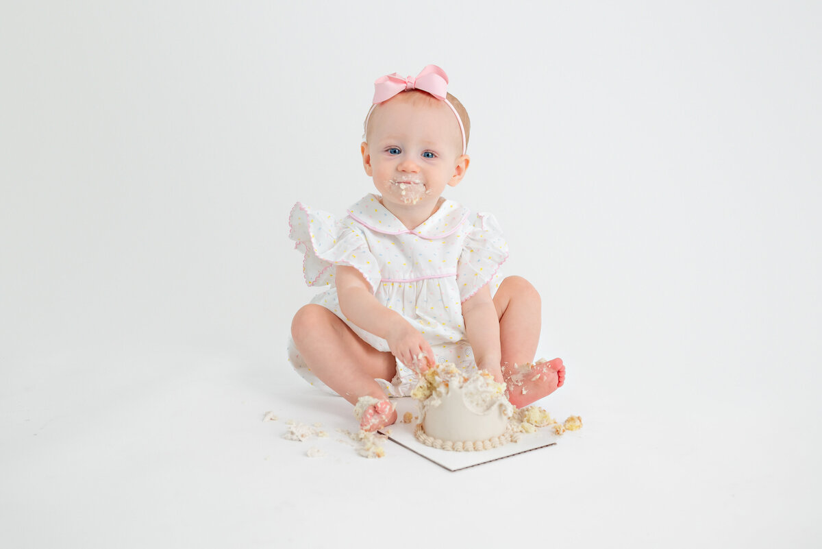 Baby eating cake for her first birthday