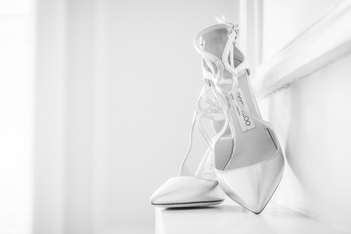 bright white photo of bridal shoes at The Muttontown Club wedding