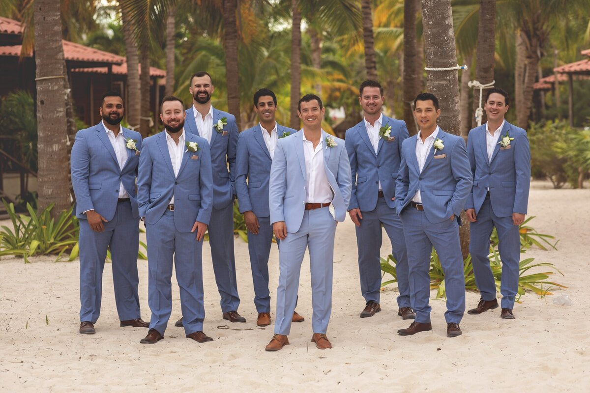 Groomsmen on beach after wedding ceremony in Riviera Maya