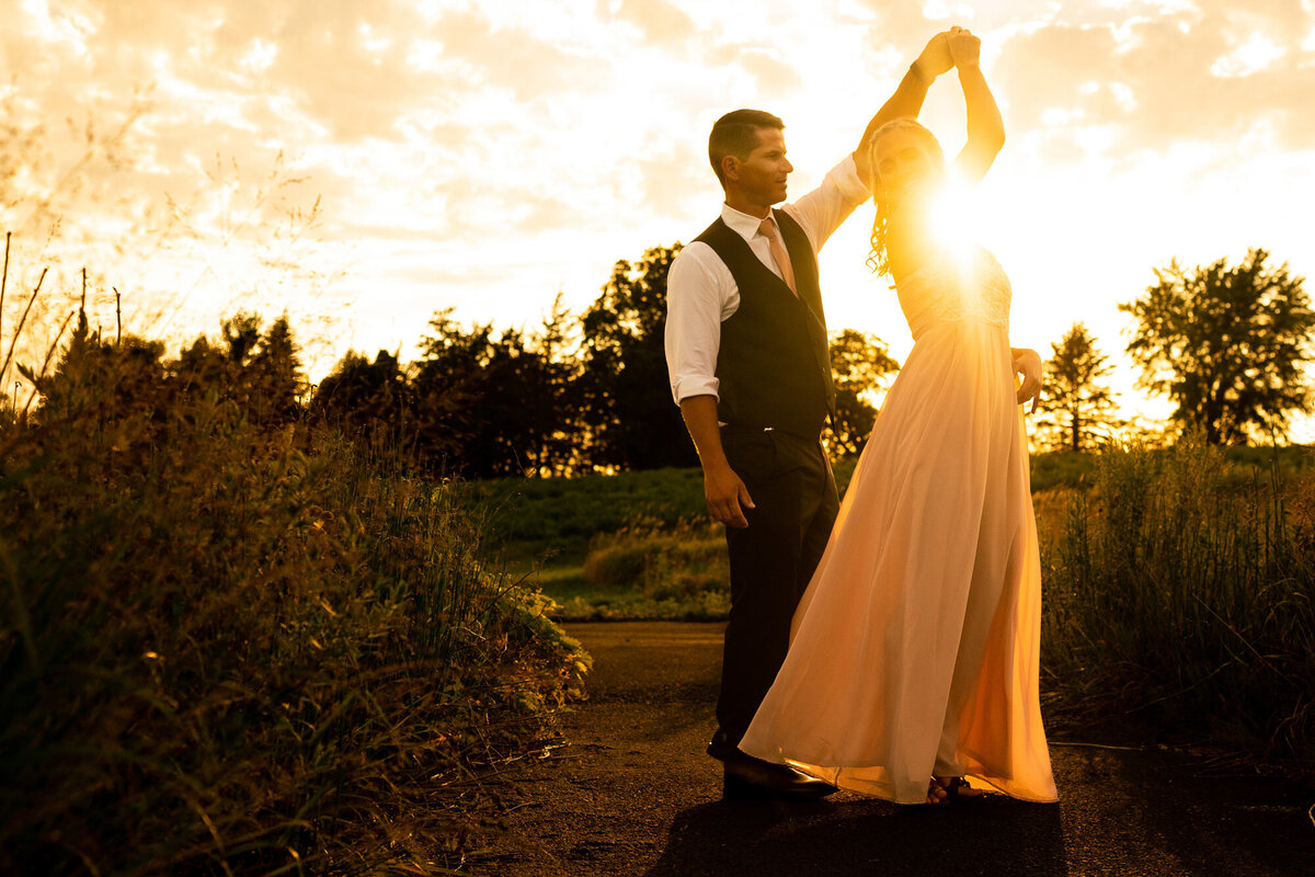 Bride and groom dance in the sunset.
