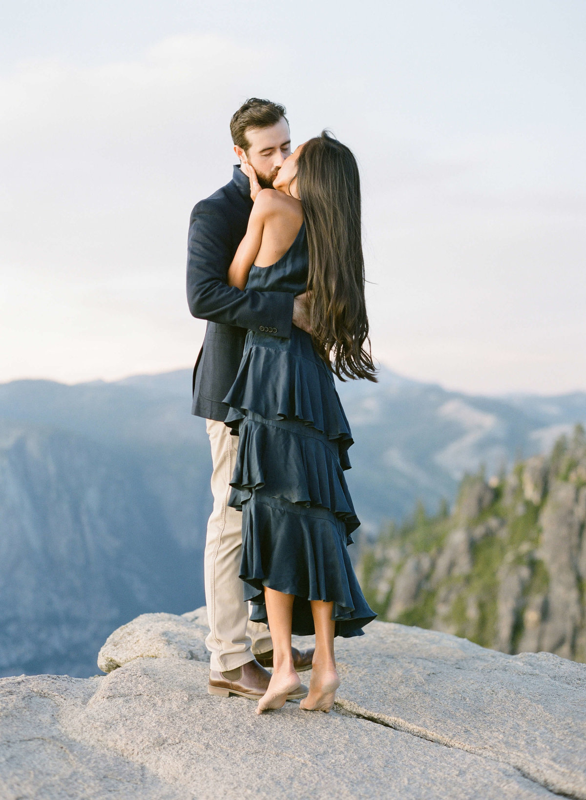 81-KTMerry-destination-engagement-Yosemite-mountain-kiss