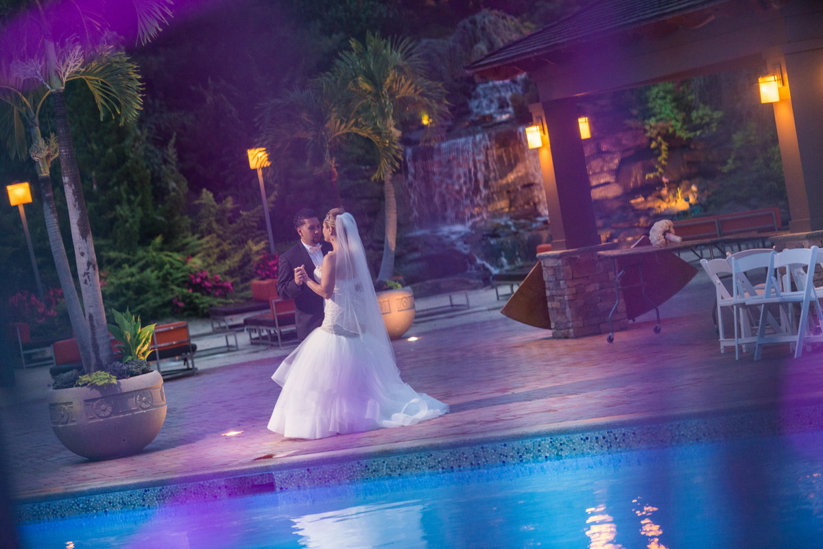 Bride and groom dancing by the pool at Crest Hollow Country Club
