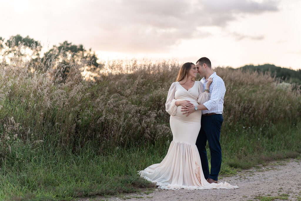 Couple embracing at sunset maternity session in a field | Sharon Leger Photography | CT Newborn & Family Photographer | Canton, Connecticut