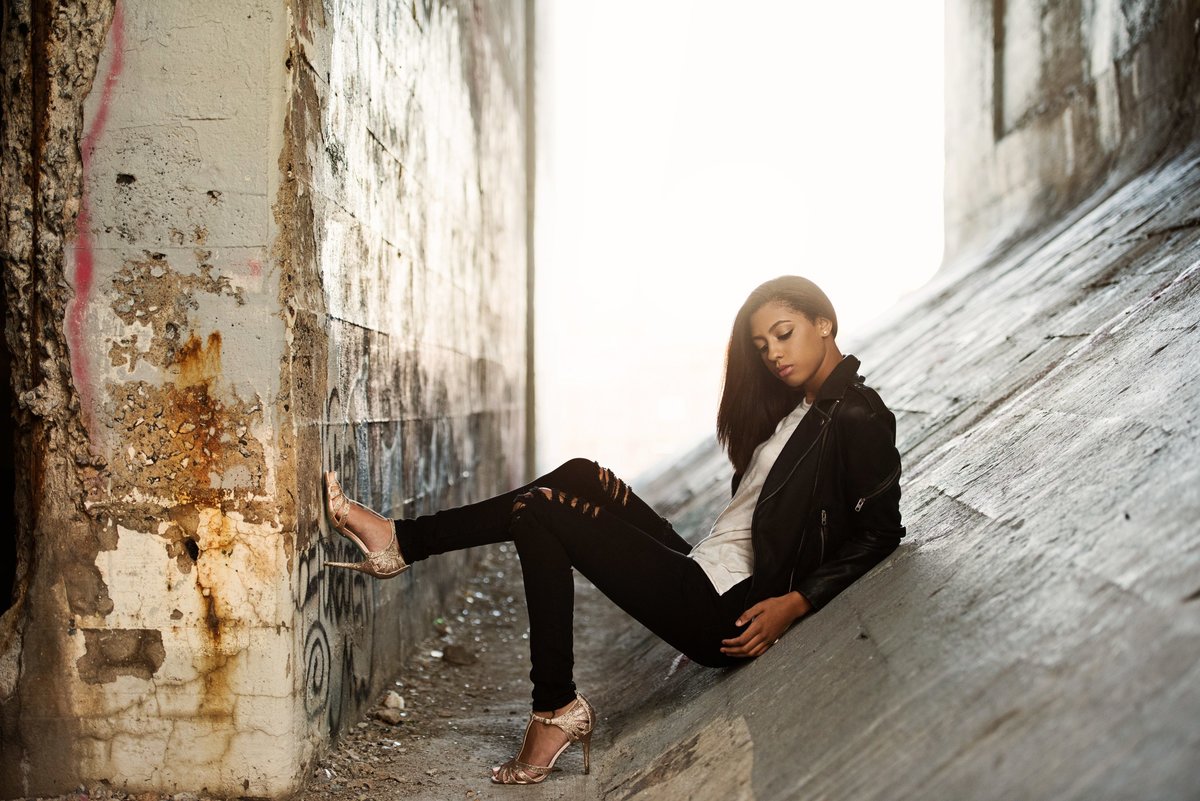high school senior photo in grungy alley location with black leather jacket