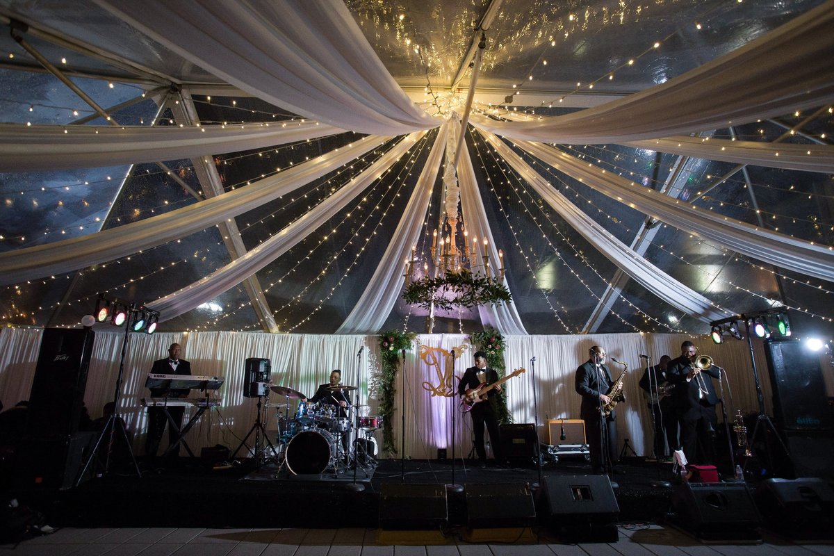 Drape and twinkle lights for tented wedding reception
