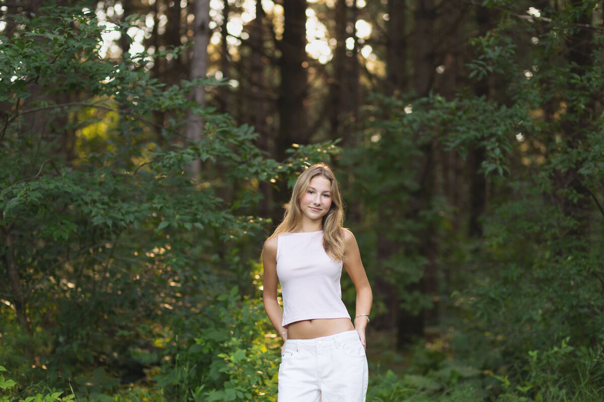 girl wearing pink shirt in the woods