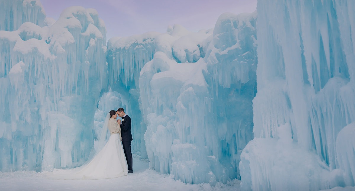 ice castles edmonton winter wedding newlyweds surrounded by ice