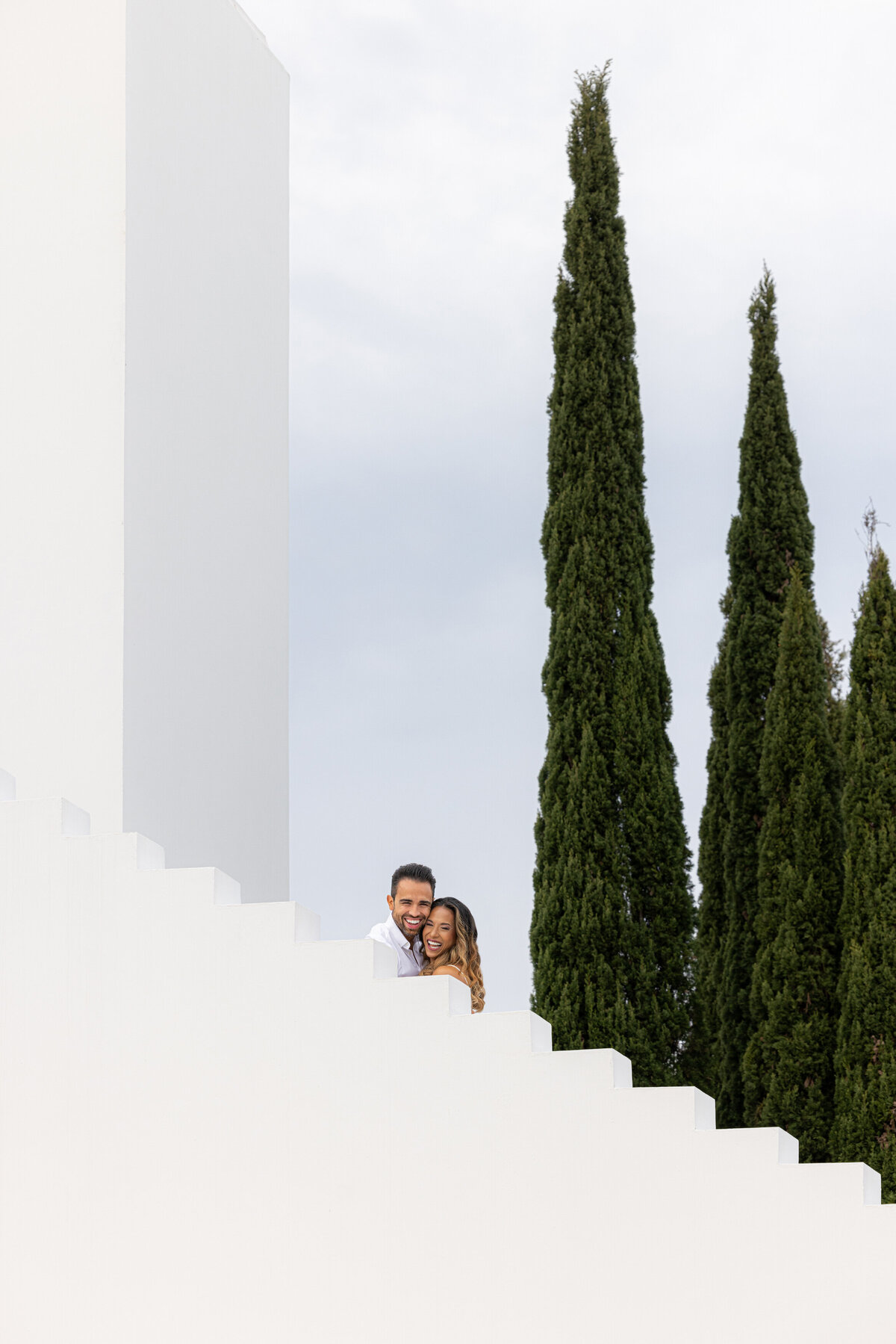 A couple hugging and standing on a staircase