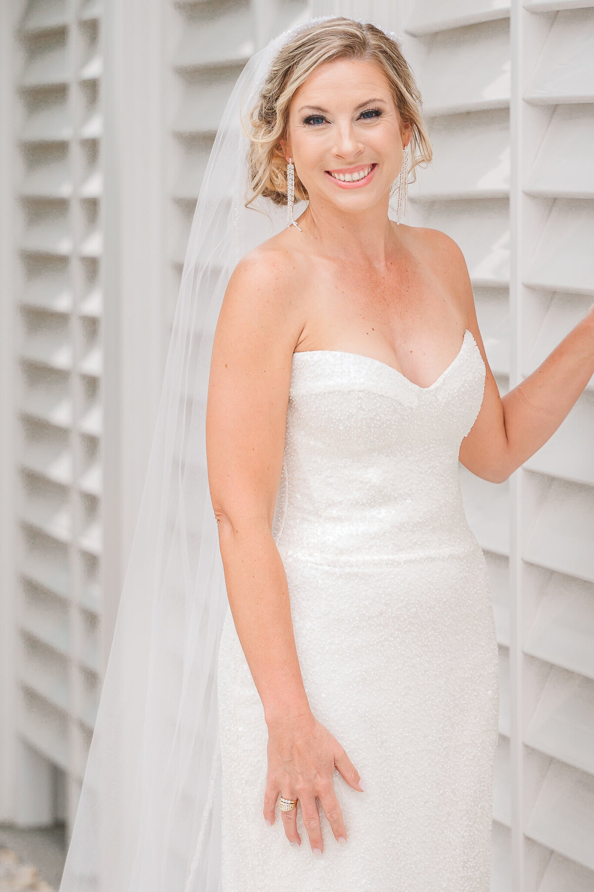 A stunning blonde bride during her bridal portrait session on  her wedding day enjoying her Raleigh wedding photography session by JoLynn Photography
