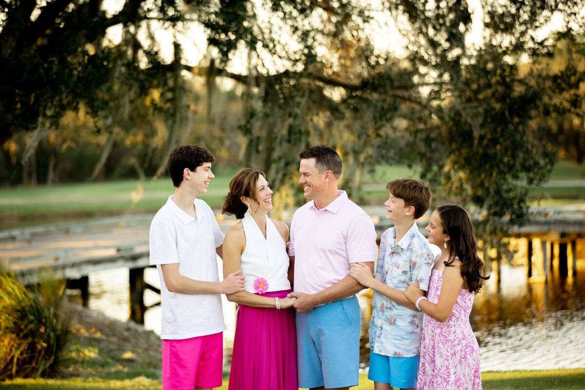 Family photo taken in Sarasota with lake and oak trees in the background