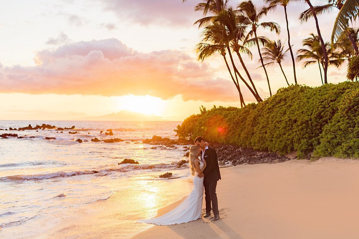 Warm light surrounds a couple honeymooning in Maui during a Love + Water beach portrait session