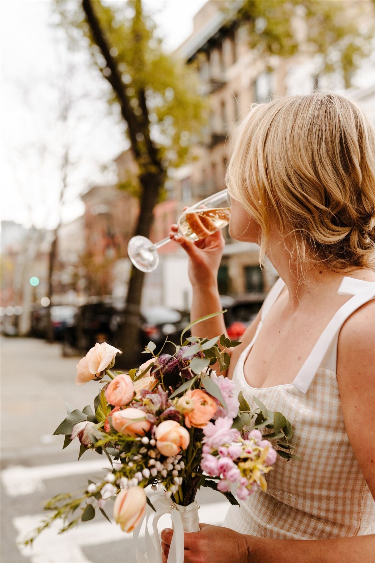 bride holding colorful flowers during wedding