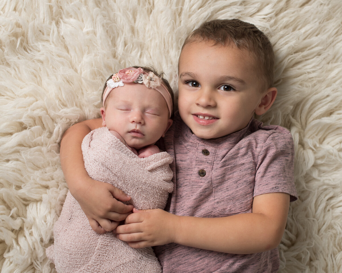 Newborn and Sibling adorable moment captured by Laura King Photography