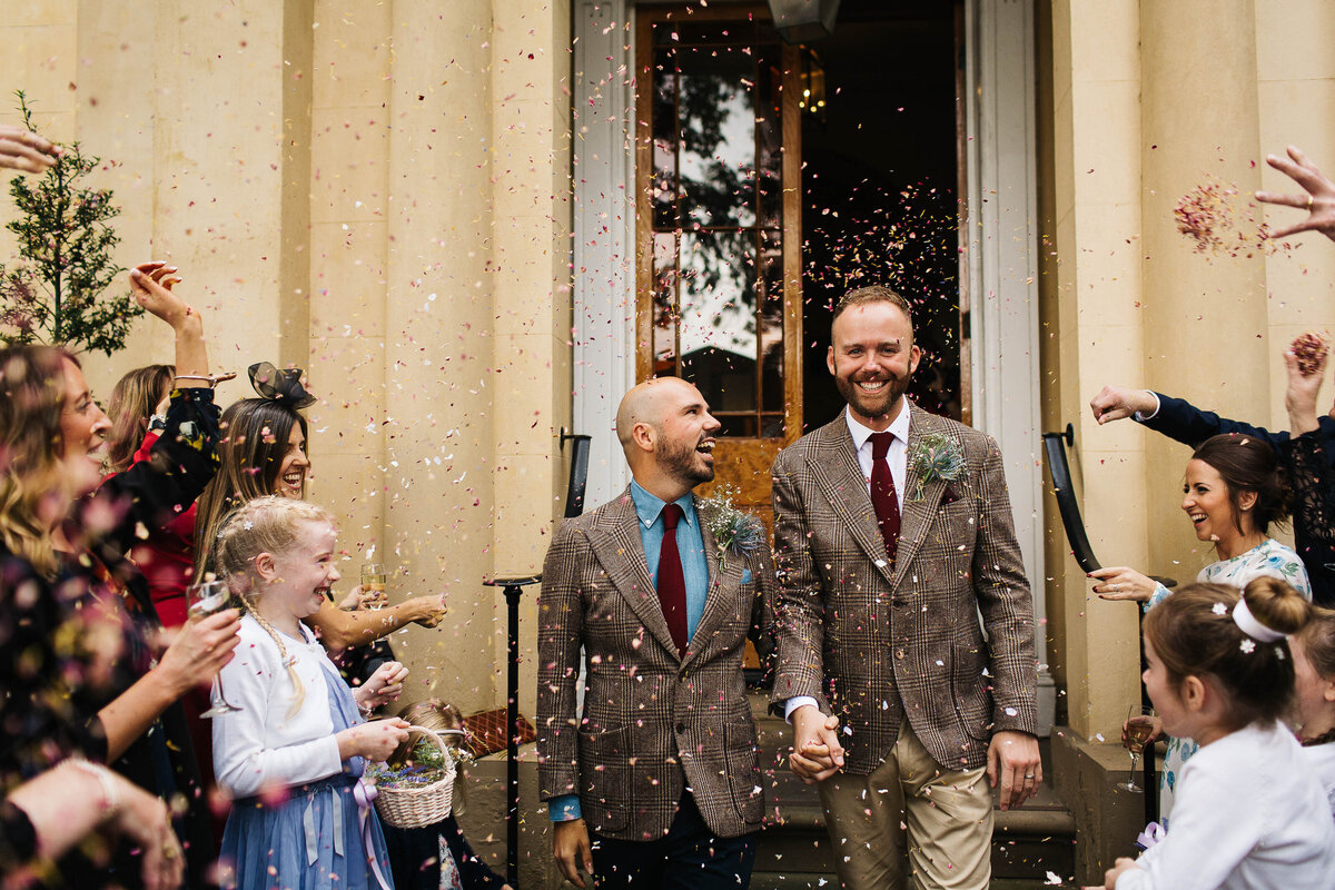 gay male couple laughing whilst exiting the ceremony at Elizabeth Gaskell’s House