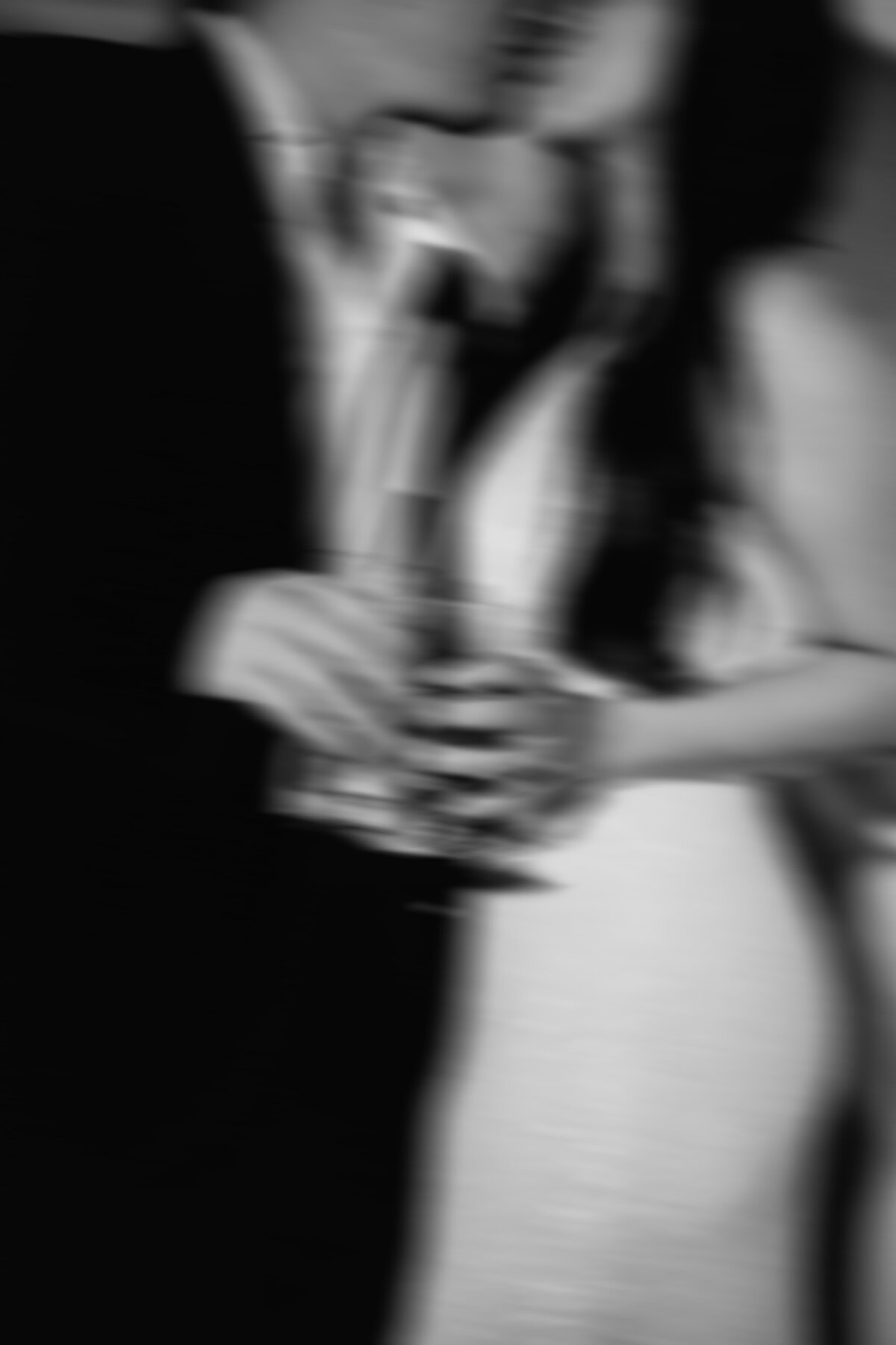 Blurry fun photo of a bride and groom kissing