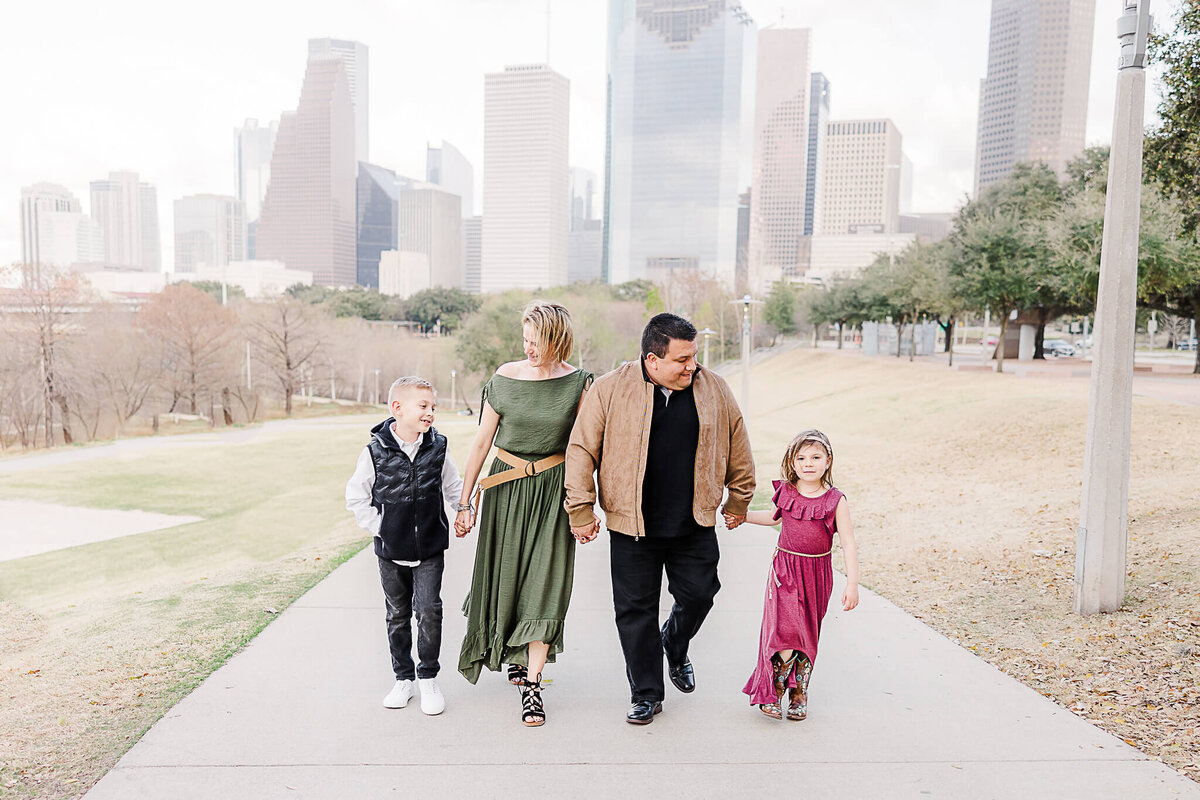 Family walking with Houston skyline in the background