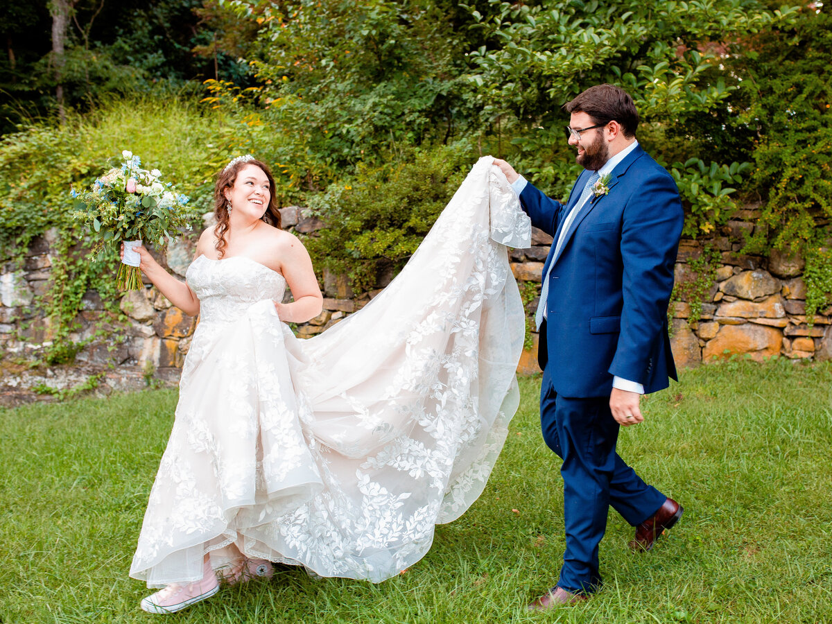 groom-carries-wedding-gown