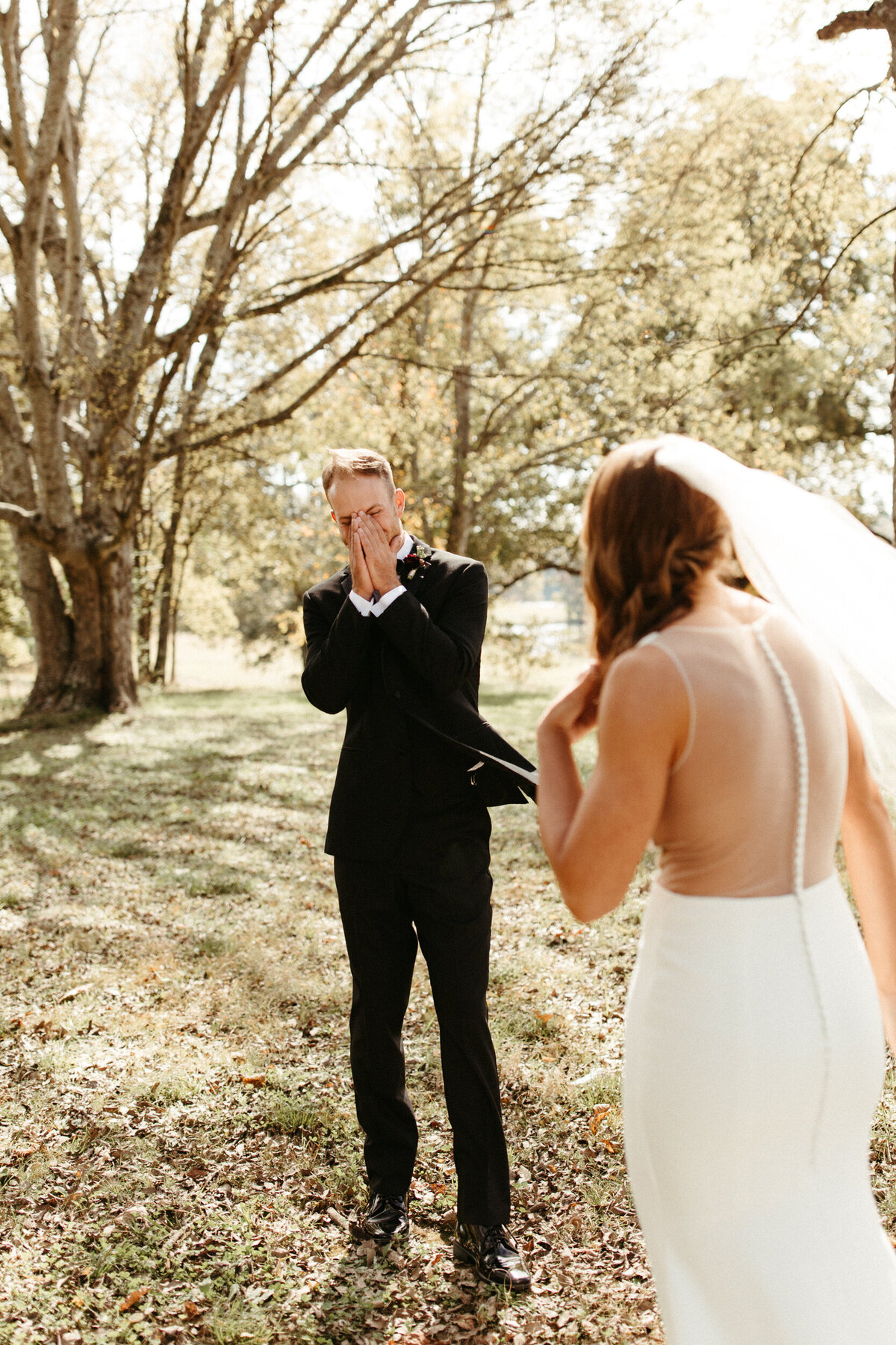 Groom getting emotional and crying during the first look with his bride