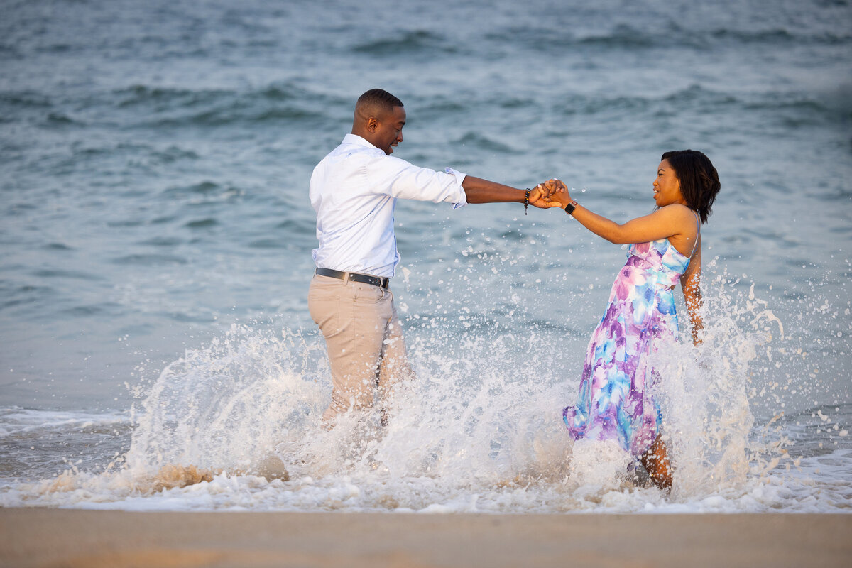 engagment-couple-playing-in-ocean-waves-asbury-park-beach