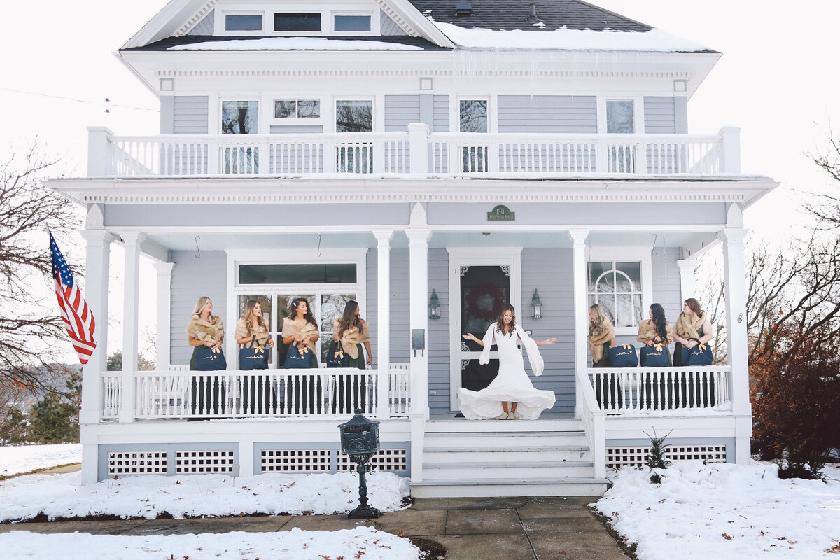 Bride and Bridesmaid having fun on house porch before wedding ceremony | By Andrew Vick Photography