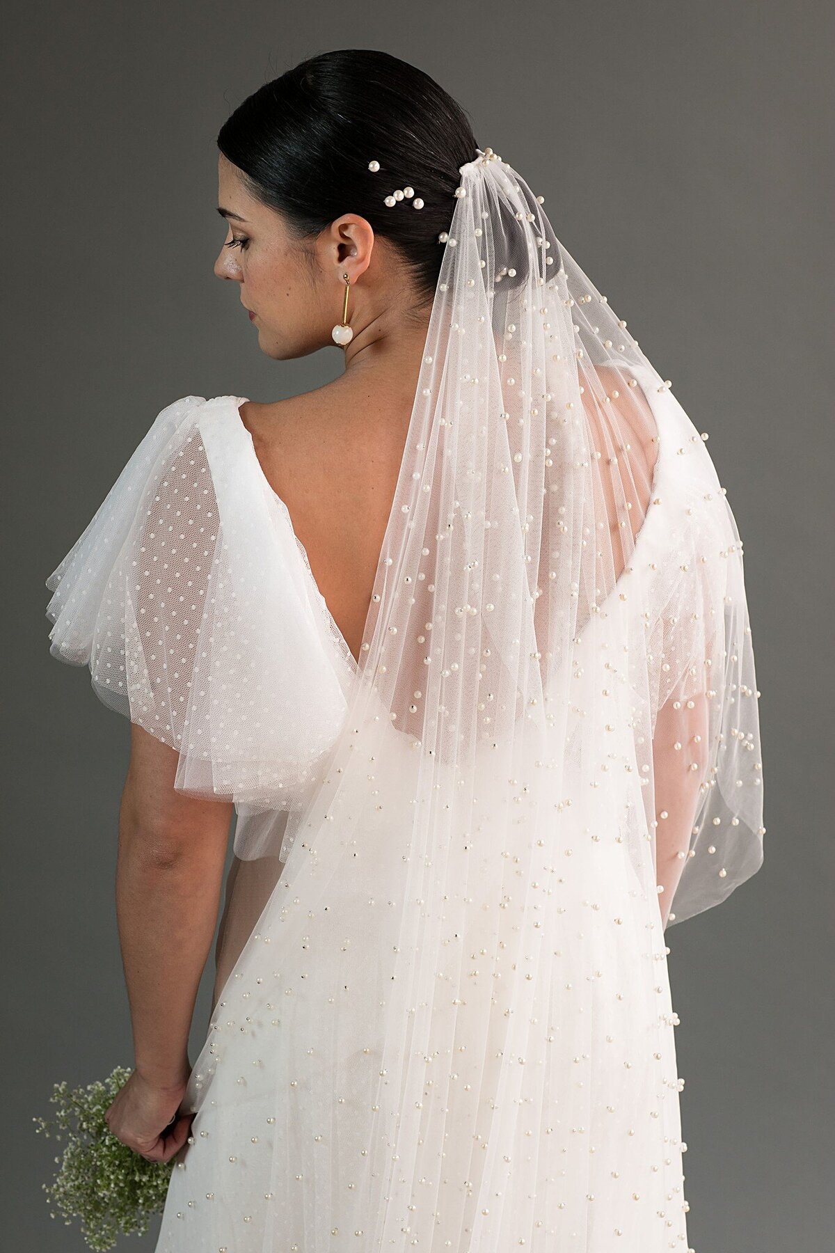 The top edge of the Pearl Veil is gathered onto a comb between the curved corners for a beautiful drapey veil.