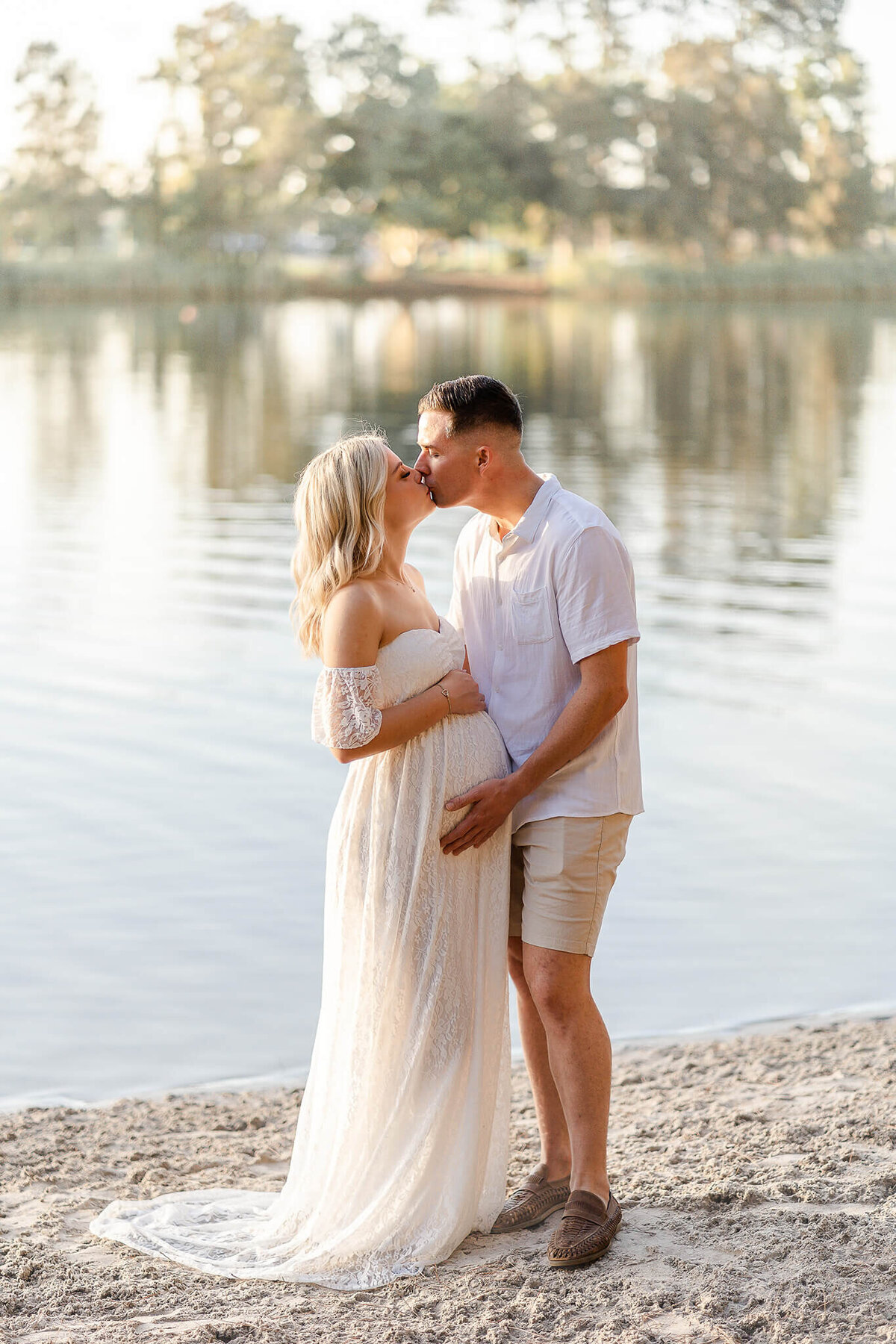 couple kissing by the lake in pizzey park golden hour gold coast