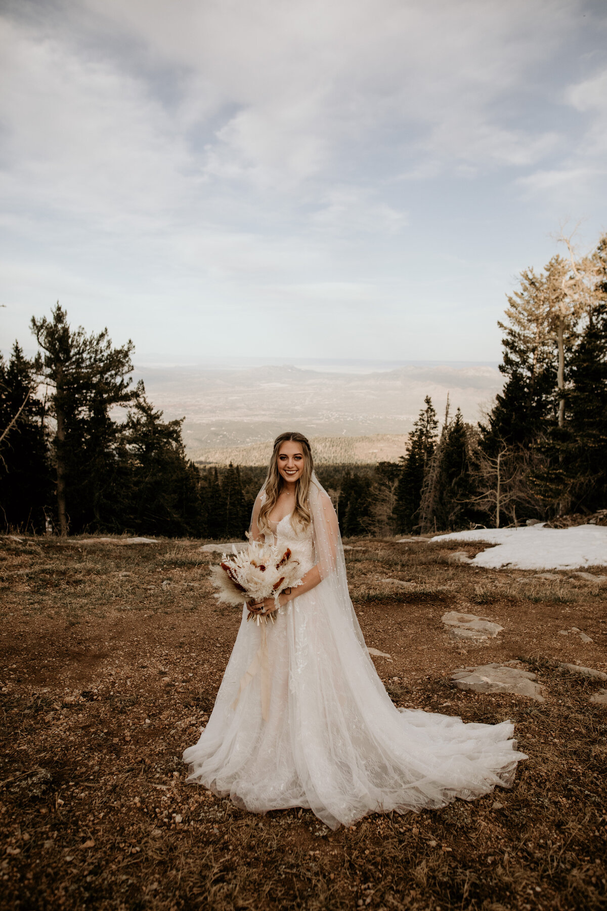 bride with bouquet on top of mountain