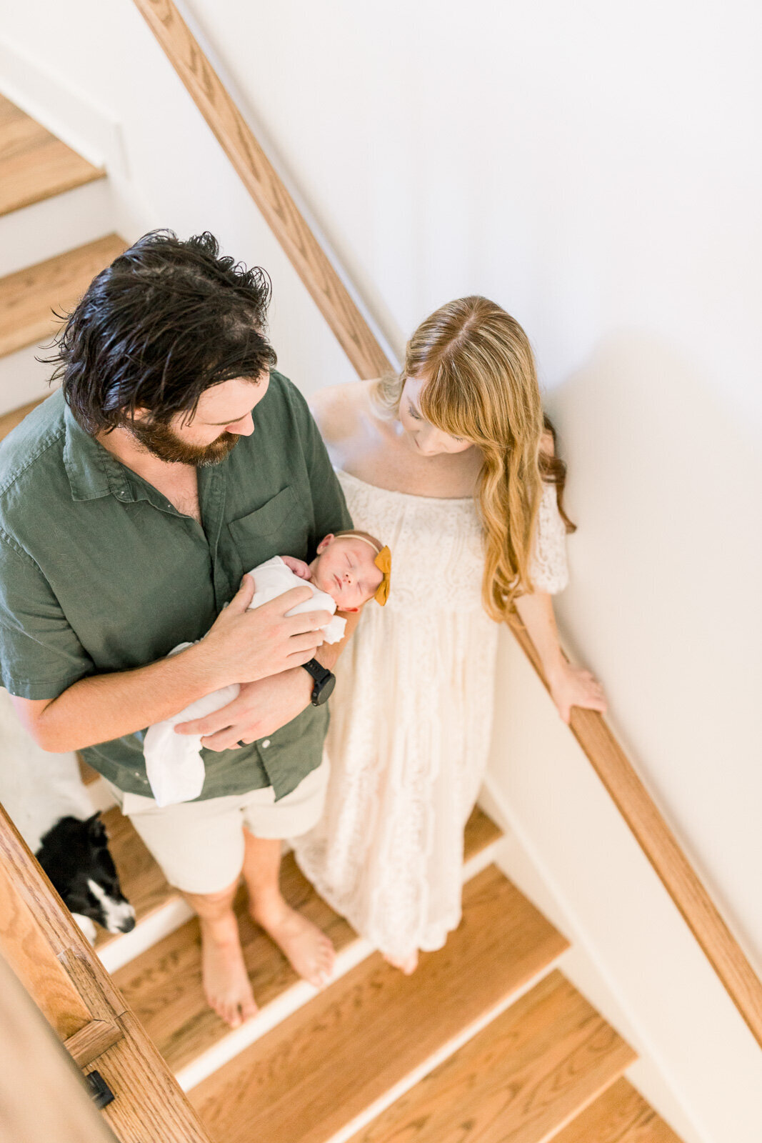 Family walking with newborn baby on stairwell