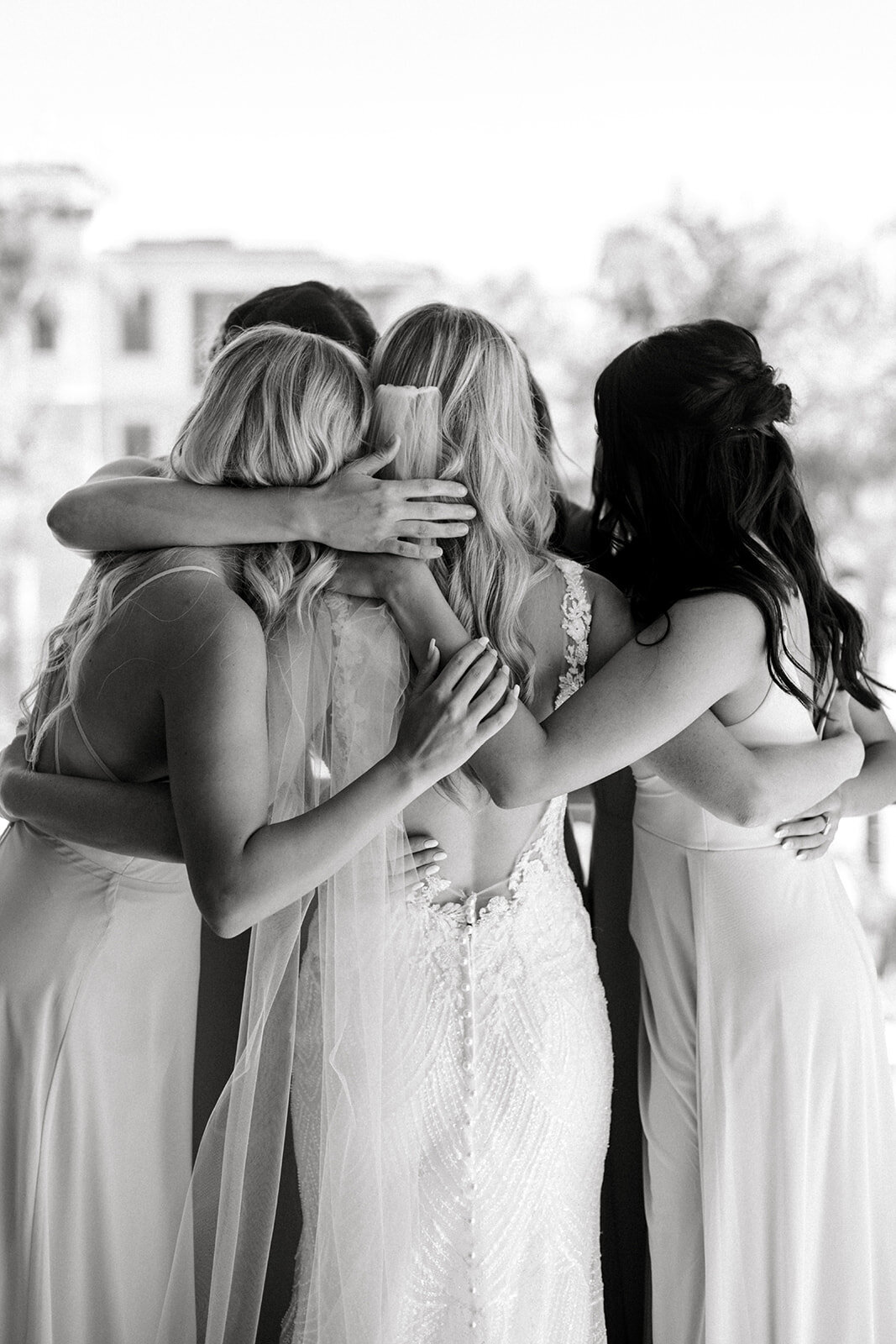 Bridesmaids wedding embrace at Dolphin Bay Resort in Pismo Beach, CA