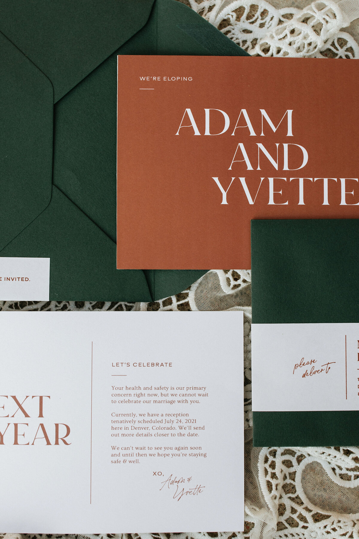 deep green envelopes and white card stock with burnt orange lettering