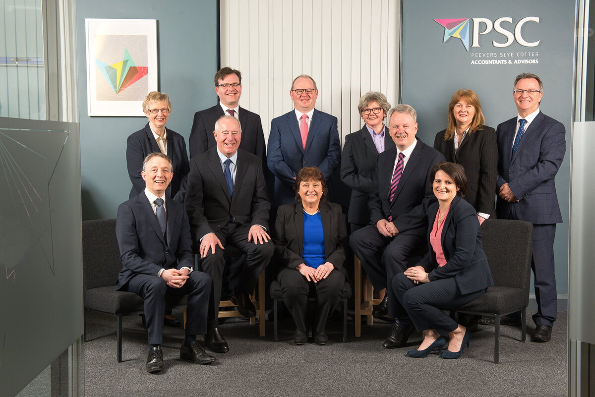 staff group at an accountancy firm wearing suits