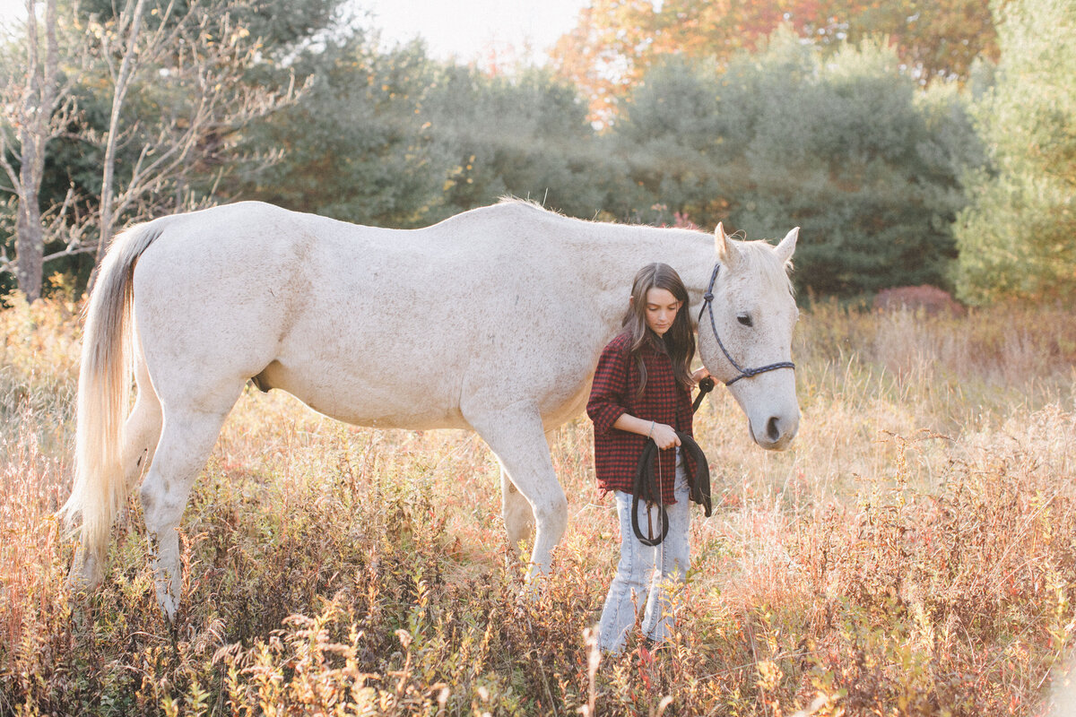 girl with horse at family photo session in new hampshire