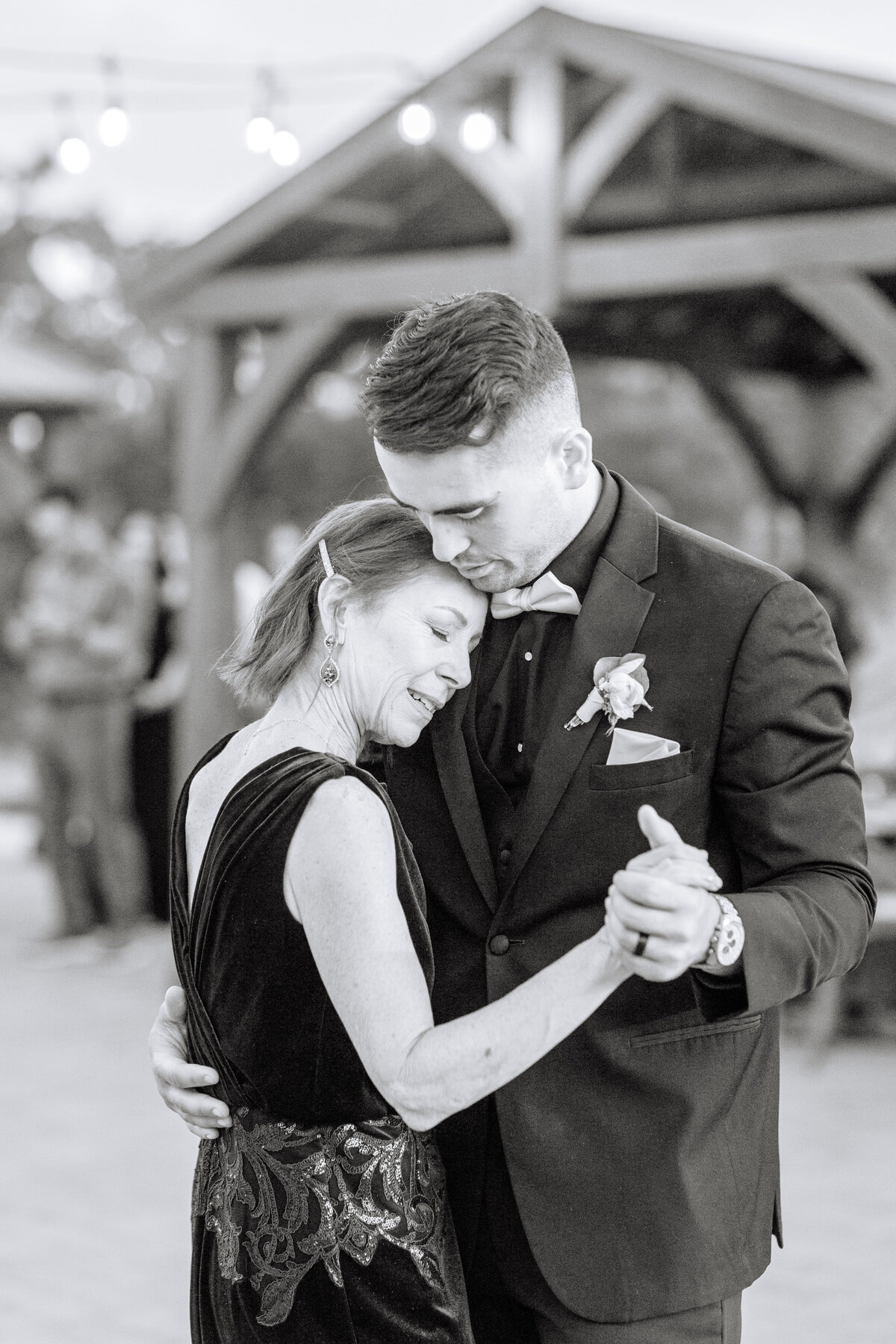 black and white image of groom dancing with his mother at napa wedding reception.