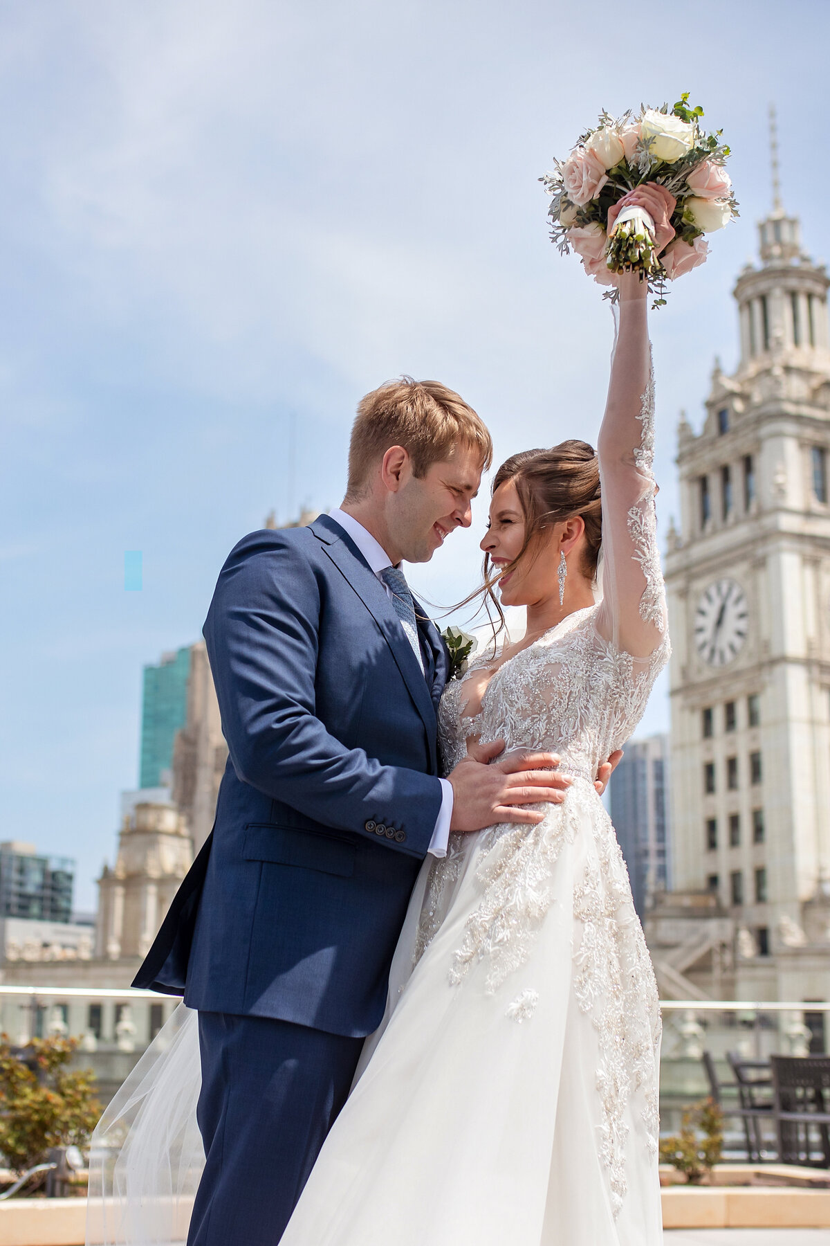 Bride and groom happy to see each other on  top of Trump tower hotel in Chicago