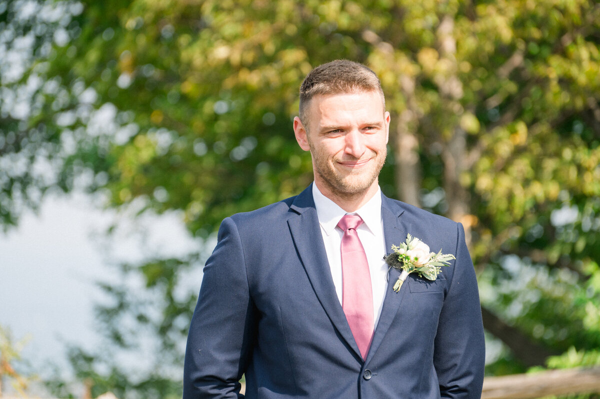 Groom at the front of the ceremony waiting for the Bride to walk down the aisle captured by Niagara wedding photographer