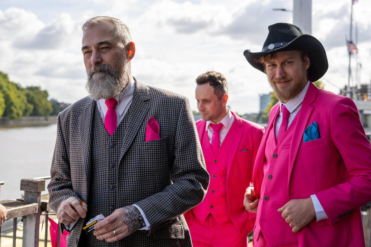 Best Men wearing pink on balcony of TRC