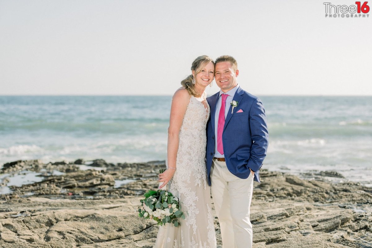 Gorgeous photo of newly married couple along the beach of Crystal Cove