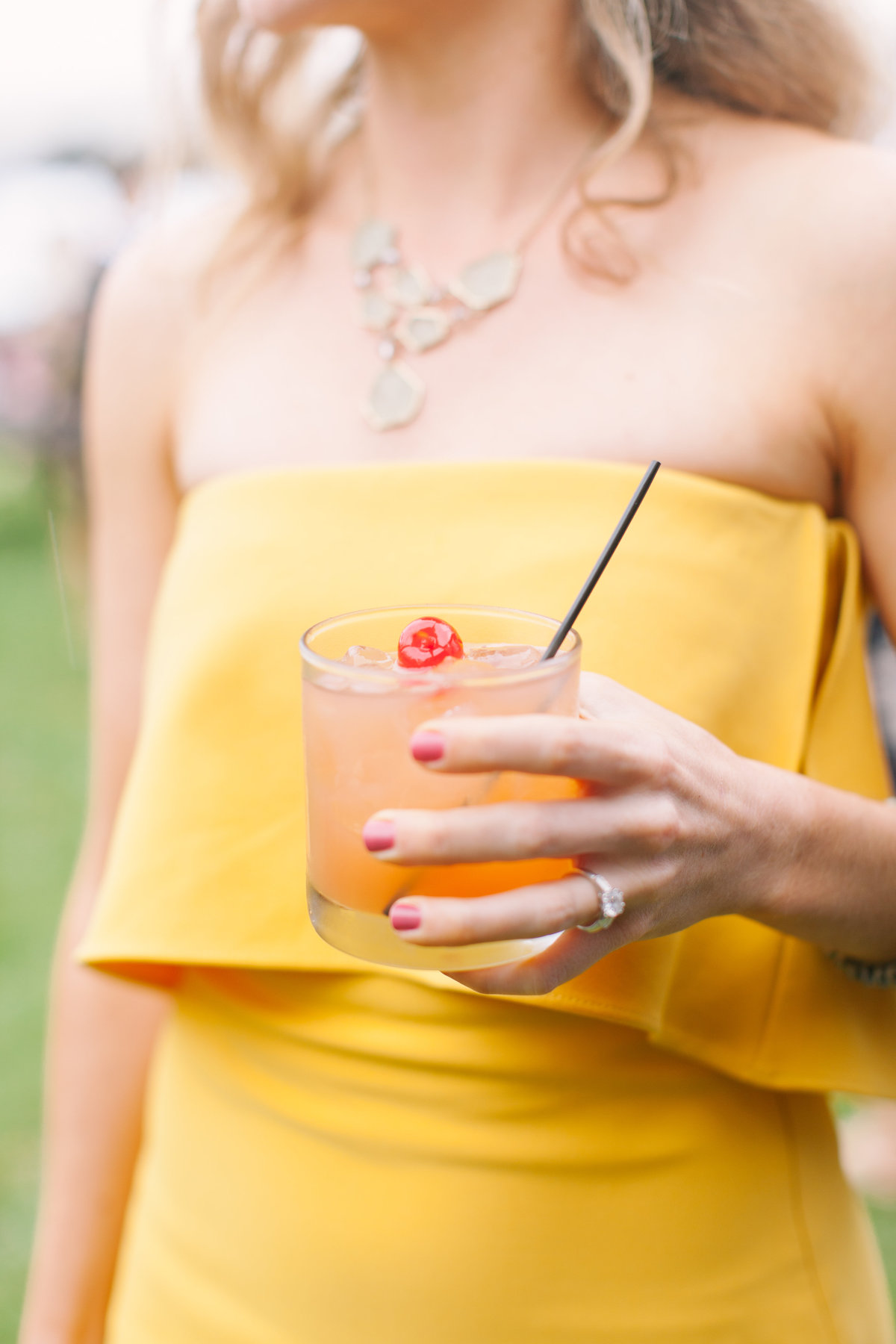 Guest in Yellow Dress holding Signature Cocktail at Charleston October Wedding